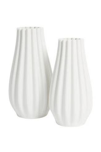 Flower Systems. Two 3D white ceramic vases with ribbed texture on a white background.