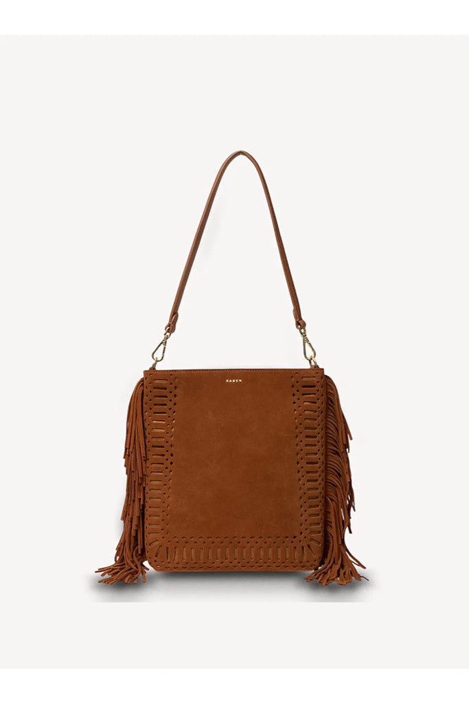 Brown suede handbag with fringe details on a white background. Saben Claudette Fringed Tassel Crossbody Bag in Tan Suede.