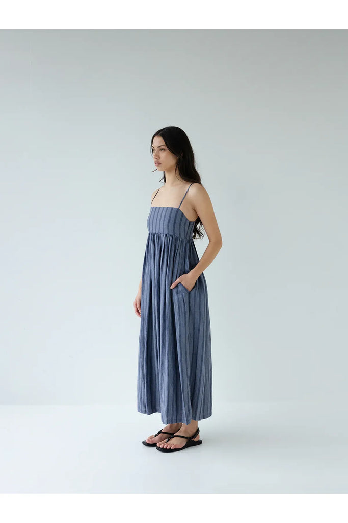 Person wearing the Sophie Go To Sundress in denim stripe.