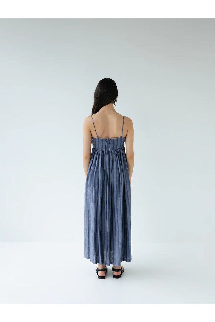 Person wearing the Sophie Go To Sundress in denim stripe.