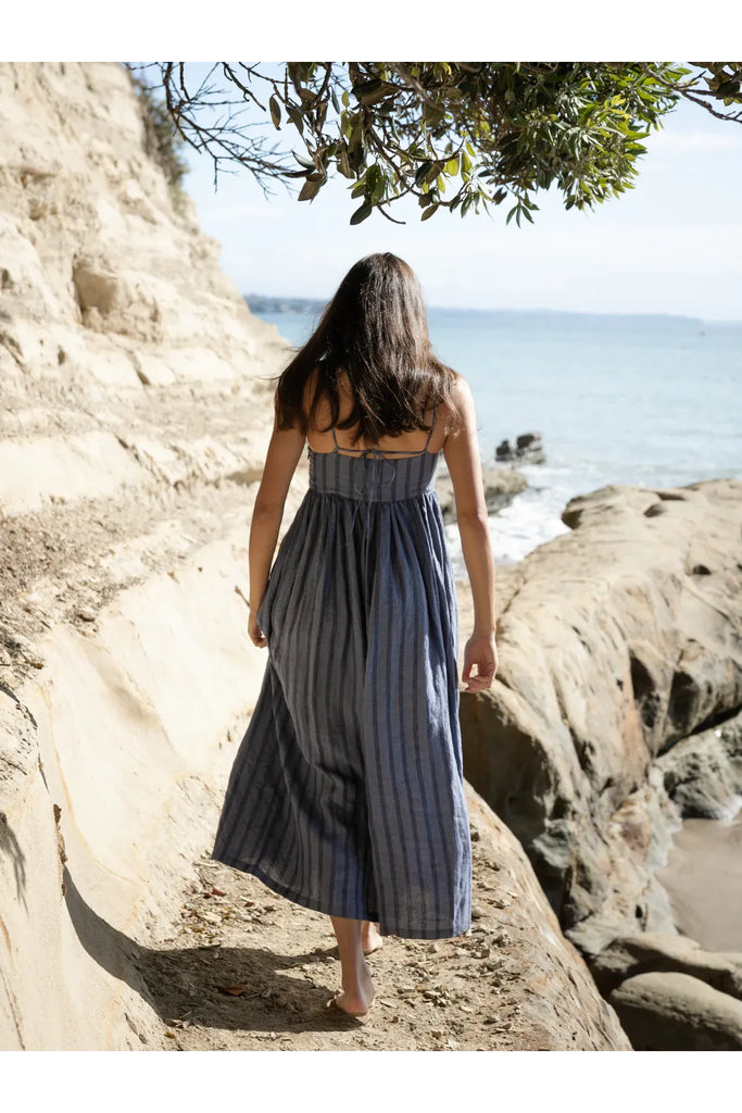 Person wearing the Sophie Go To Sundress in denim stripe at the beach