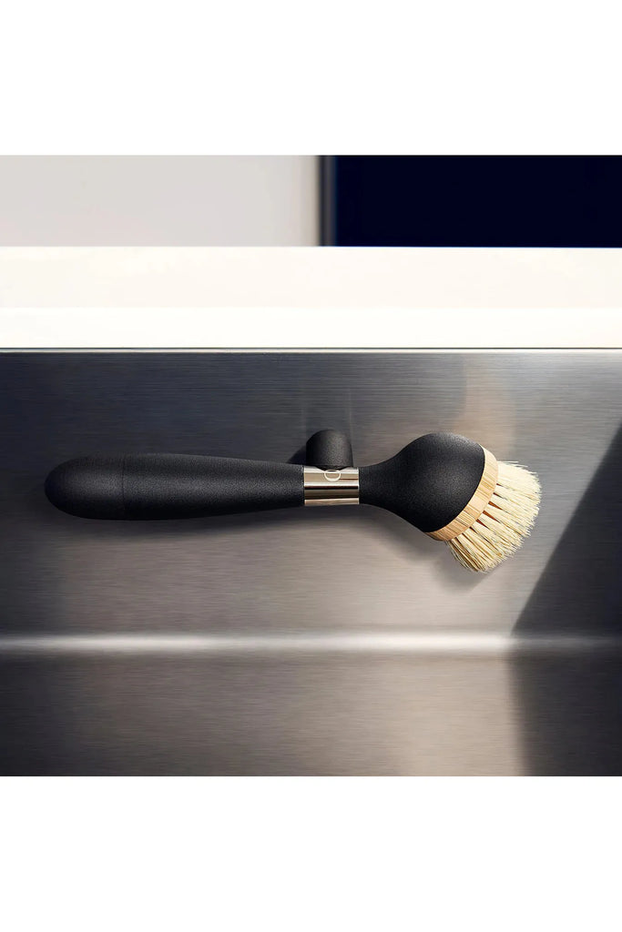 Yeseco.life One Brush The Ultimate Dish Brush Black Handle. Front View of the Dish Brush being held in the Sink on the magnetic stand.