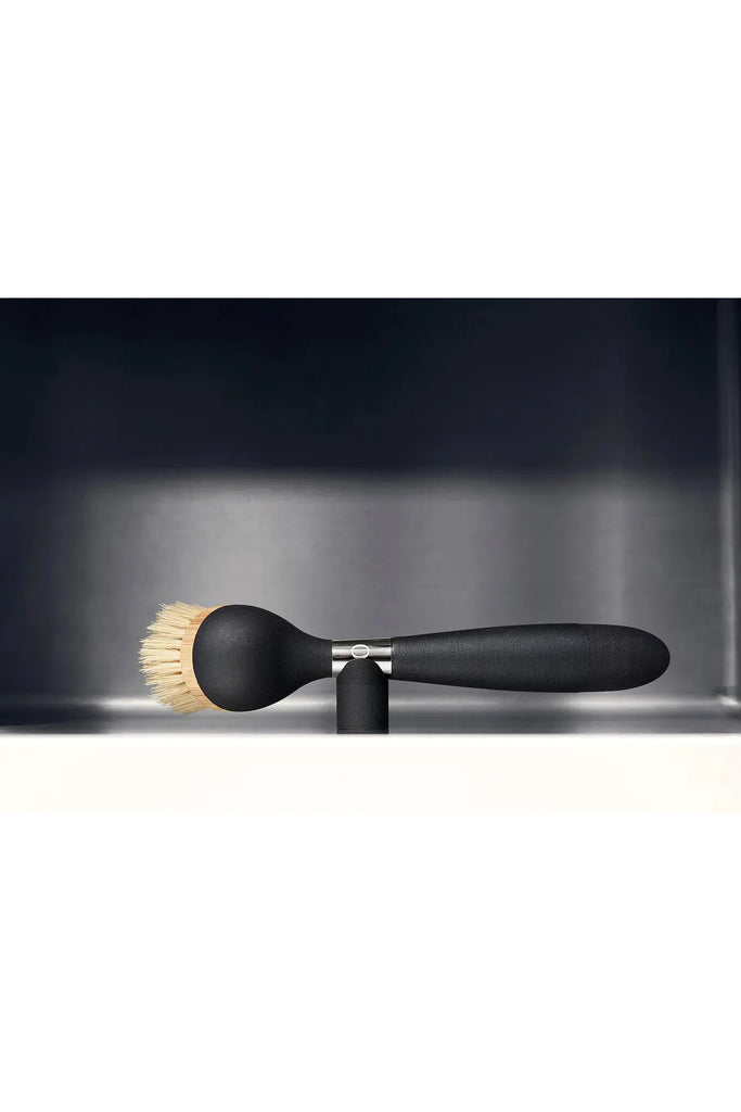 Yeseco.life One Brush The Ultimate Dish Brush Black Handle. Looking Down on Top of the Dish Brush being held in the Sink on the magnetic stand.