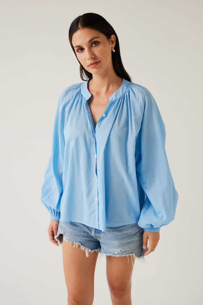 Tuesday Label Pioneer Top, blouse in sky blue on model with jean shorts