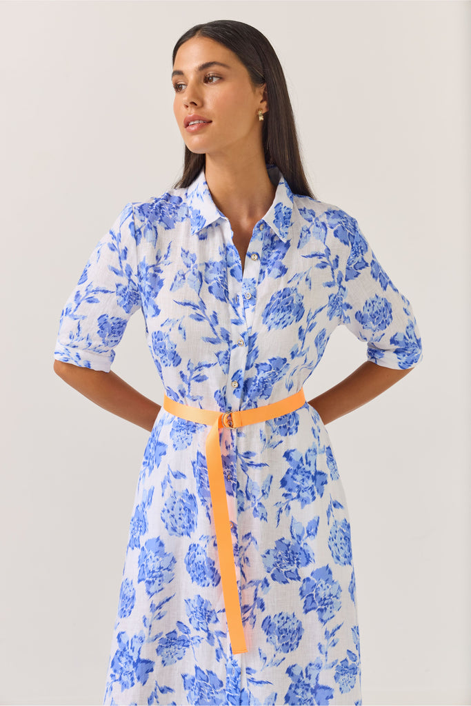 Woman wearing a blue floral dress on a white background. Tuesday Label Nicola dress in Blue Rose. 