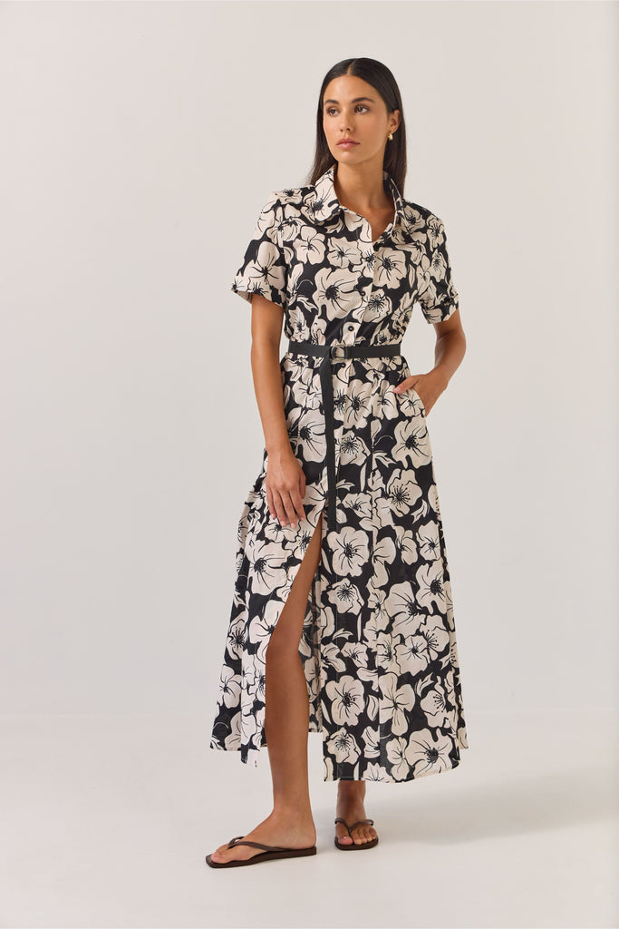 Woman wearing a black and white floral dress on a white background. Tuesday Label Godet Shirt Dress