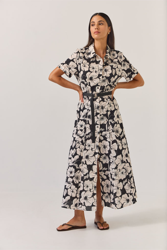 Woman wearing a black and white floral dress on a white background. Tuesday Label Godet Shirt Dress