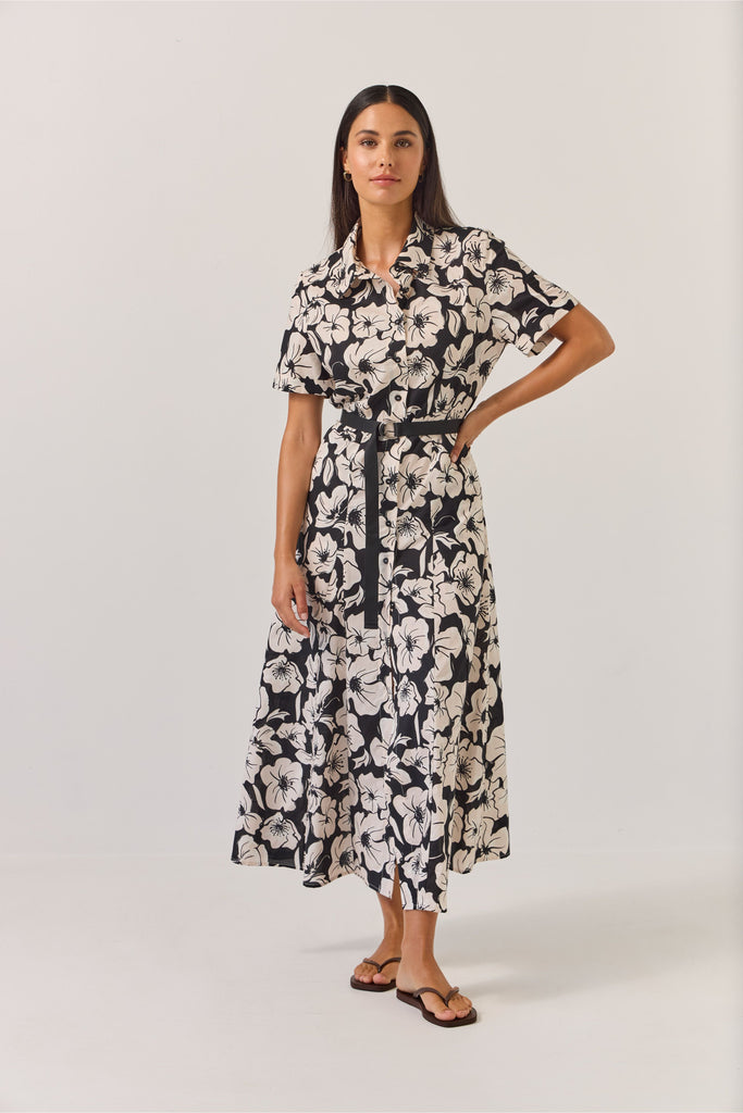 Woman wearing a black and white floral dress on a white background. Tuesday Label Godet Shirt Dress
