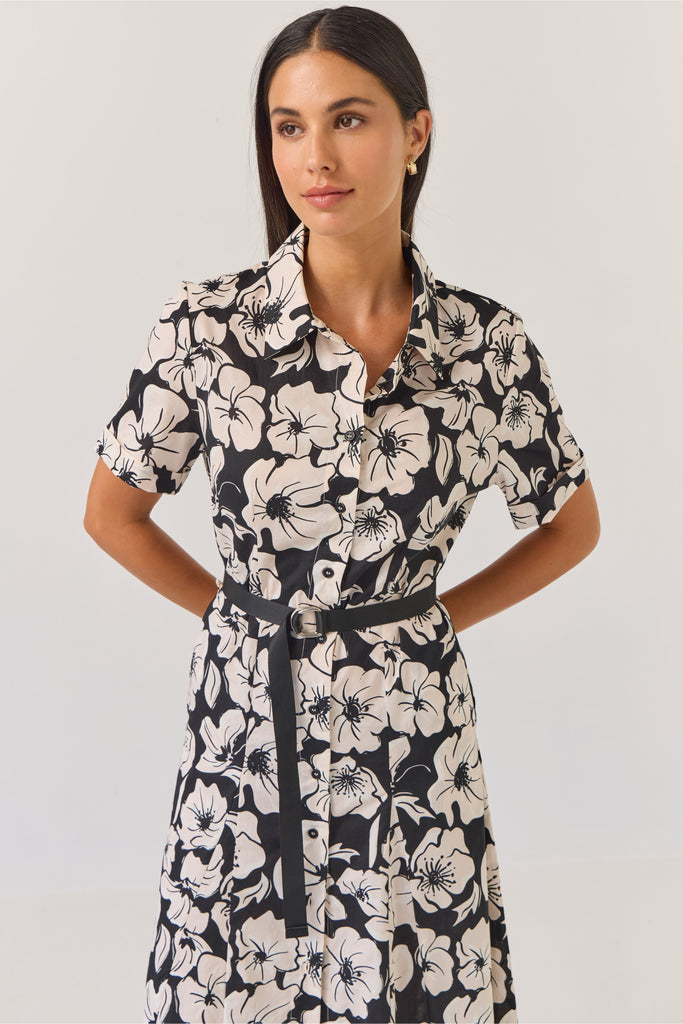 Woman wearing a black and white floral dress on a white background. Tuesday Label Godet Shirt Dress