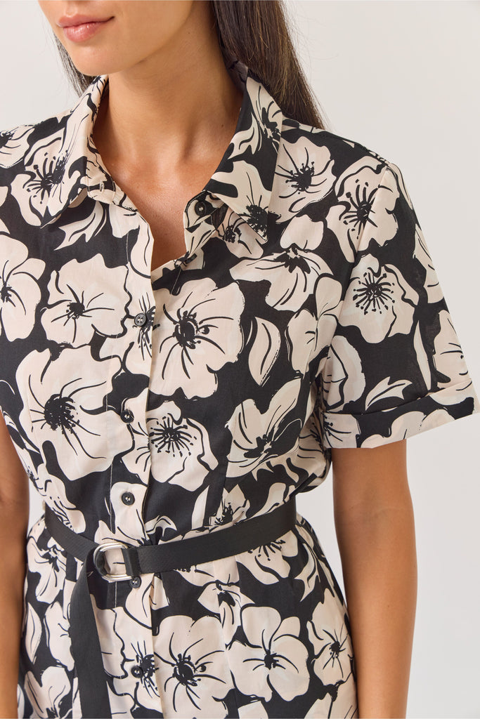 Woman wearing a black and white floral dress on a white background. Tuesday Label Godet Shirt Dress
