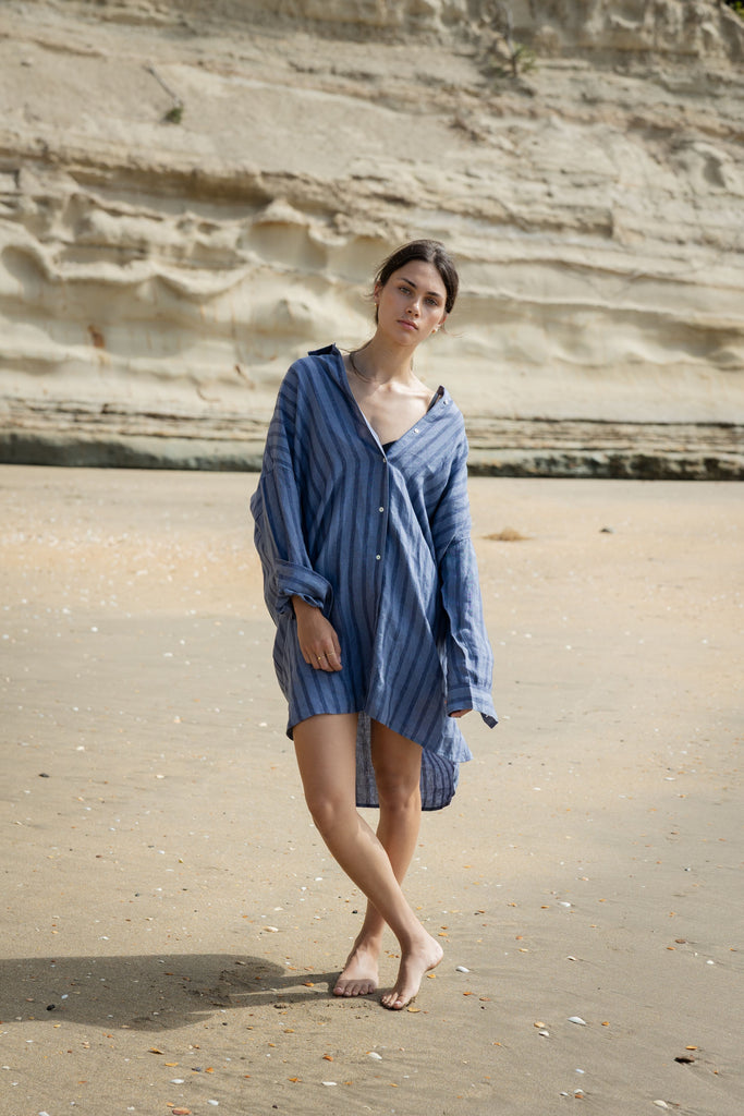 Woman wearing a blue striped shirt dress. Sophie Always Shirt dress in Denim Stripes.