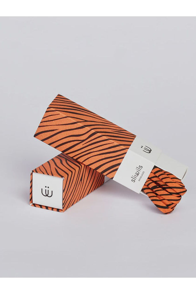 Orange tiger stripe patterned shoelaces with matching packaging on a light grey background