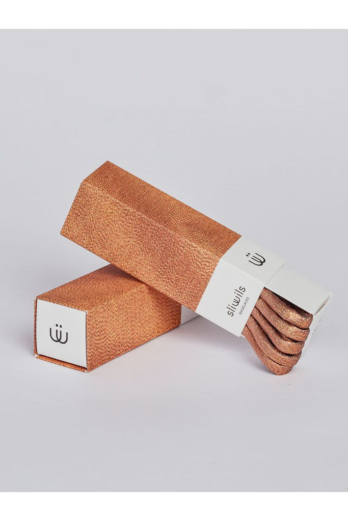 Shiny Bronze shoelaces on a light grey background