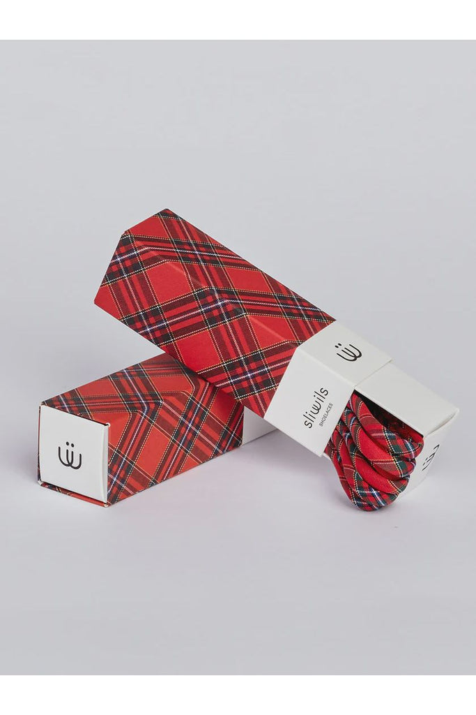Red plaid patterned shoelaces with packaging on a light grey background