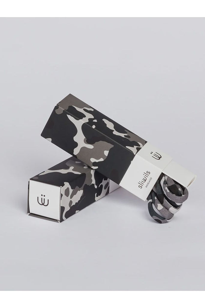 Camouflage-patterned shoelaces with packaging on a light grey background