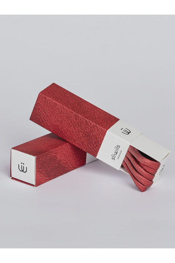 Red shiny shoelaces with matching packaging on a light grey background