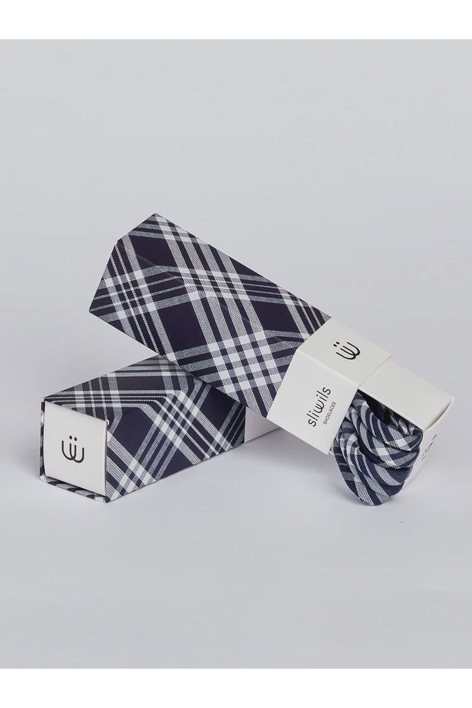 Plaid-patterned shoelaces with packaging on a light grey background