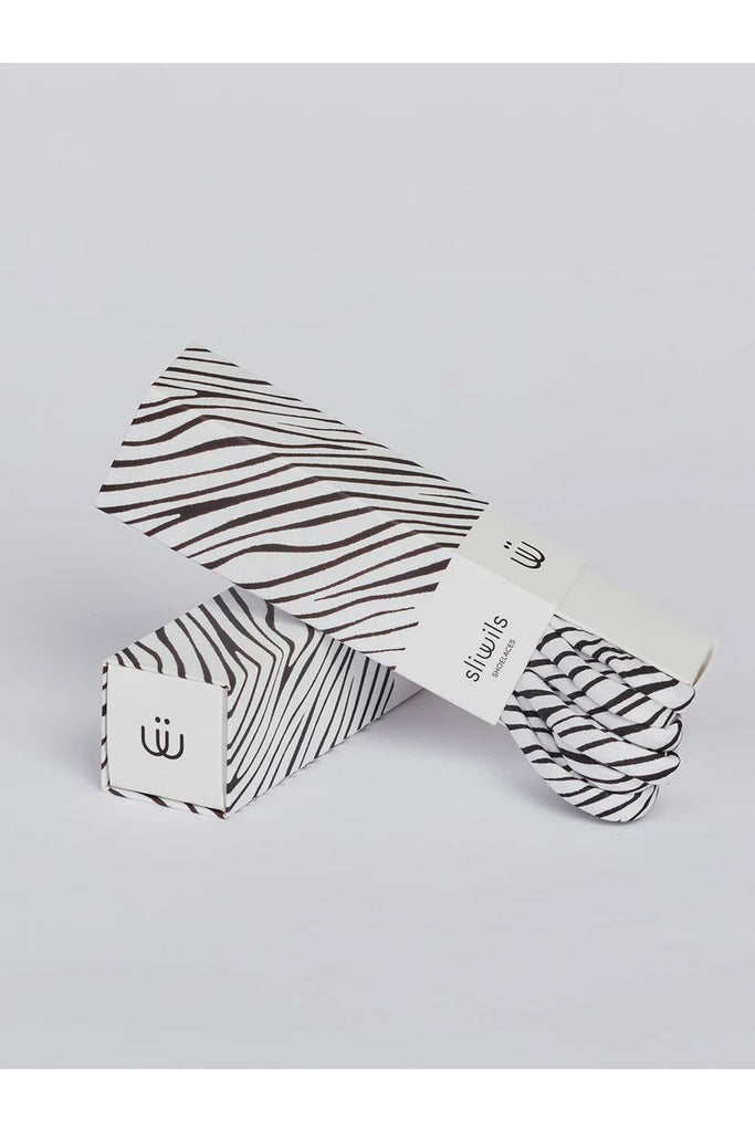 Zebra-patterned shoelaces with matching packaging on a light grey background