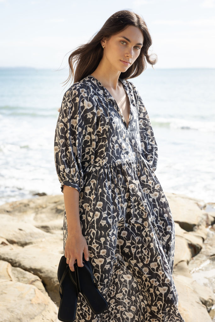 Woman wearing a Sophie Cotton Midi Dress in Coast floral print at the beach