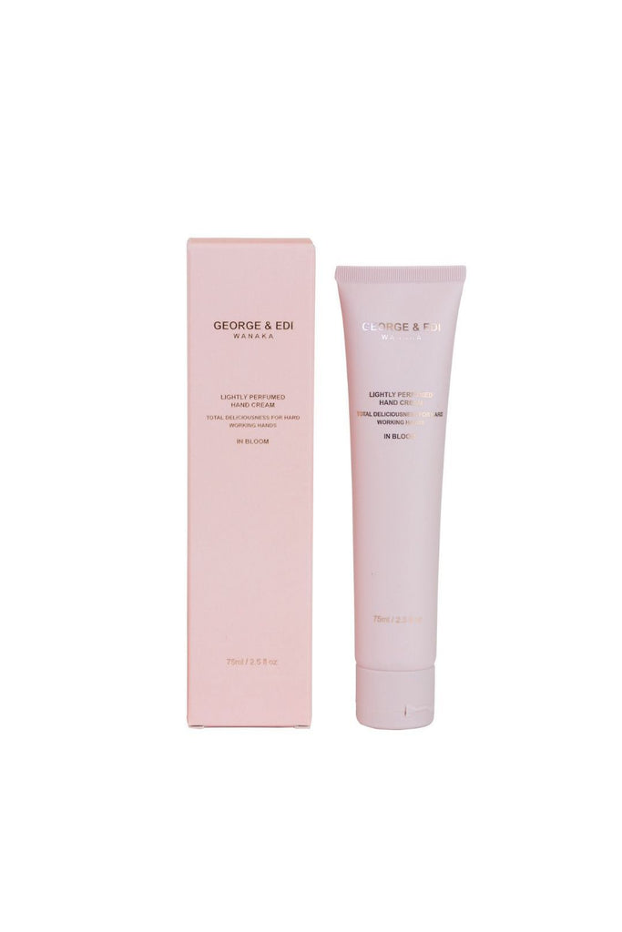 Pink hand cream tube and packaging with 'George & Edi' branding on a white background