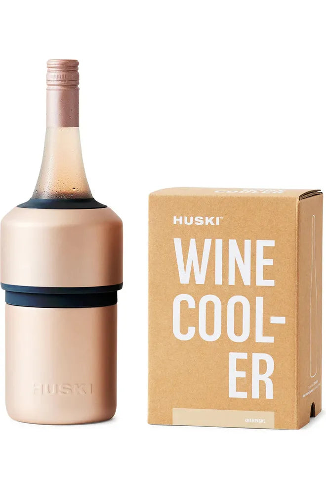 Huski Wine Cooler in Champagne Colourway.  Image shows Wine Cooler holding a chilled bottle of Rose sitting beside the Kraft Giftbox the Wine Cooler comes in.