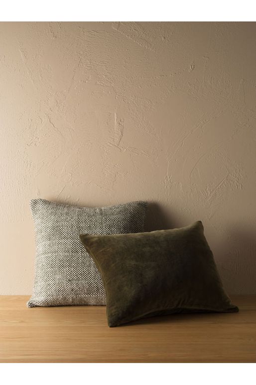 Citta Hutt Cushion in Ivy sitting behind a Citta Velvet Cushion 