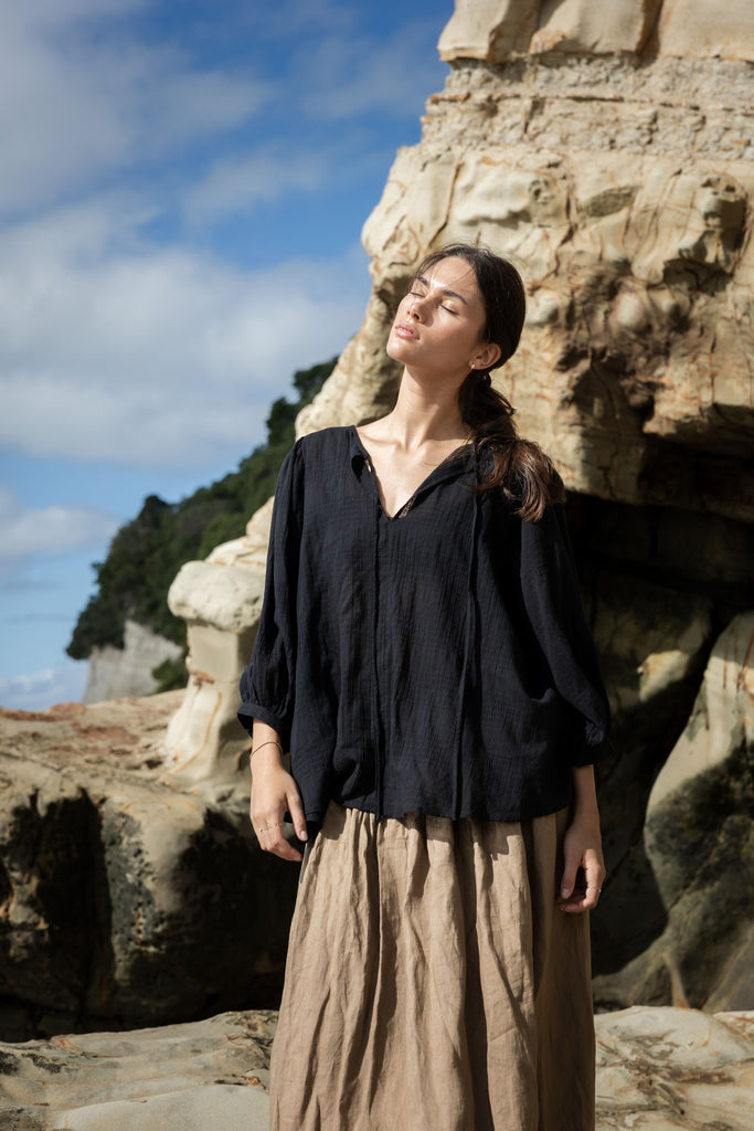 Woman wearing a black outfit at the beach. Sophie Tie Top in black Check.