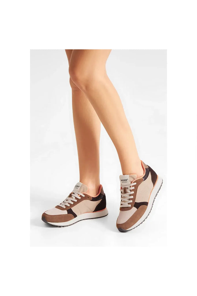 Pair of brown and beige sneakers with white laces on a light gray background. Woden Ronja Sneakers in Coffee Cream