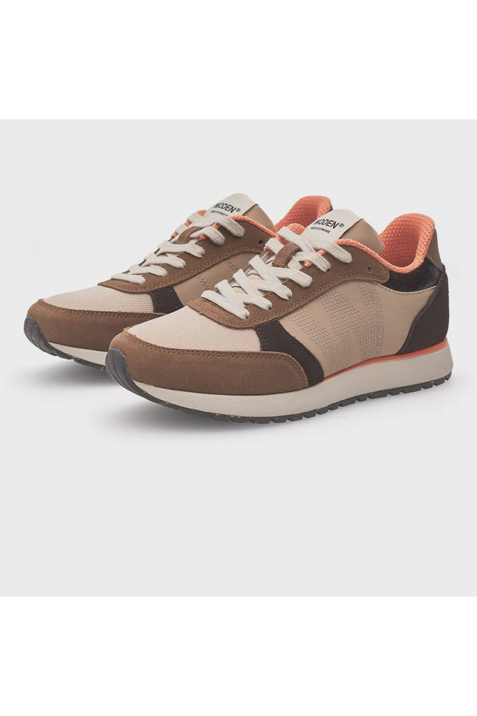 Pair of brown and beige sneakers with white laces on a light gray background. Woden Ronja Sneakers in Coffee Cream