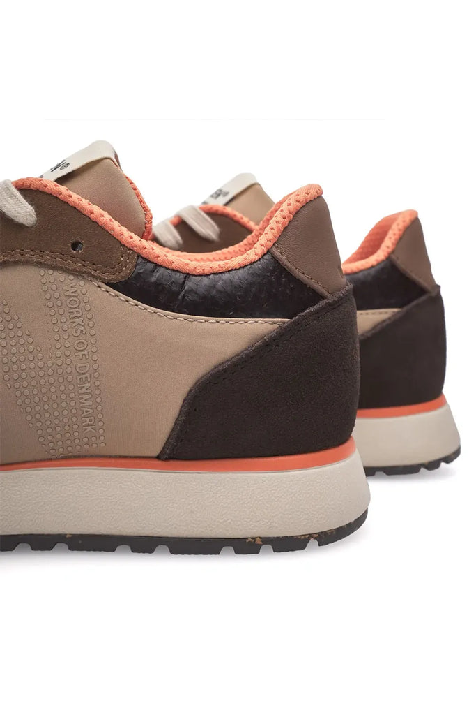 Pair of brown and beige sneakers with white laces on a light gray background. Woden Ronja Sneakers in Coffee Cream