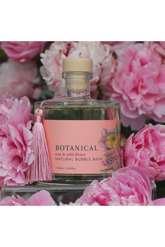 Botanical Skincare Limited Edition Bubble Bath Rose + Wildflower bottle displayed amongst flowers